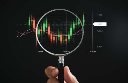 A trader's strategic approach to the stock market, seen through the magnifying glass that enhances the technical graph of the bar chart, signaling profitable investment concepts.