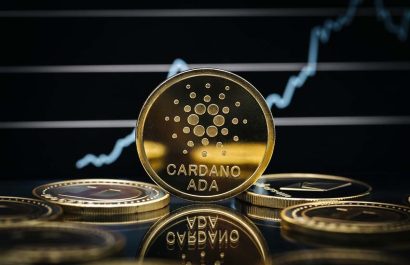 KAUFBEUREN, GERMANY - AUGUST 28, 2021. Cardano Ada cryptocurrency coin close-up, in front of a price chart.