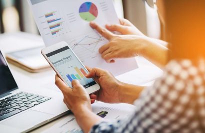 Two business woman investment consultant analyzing company annual financial report balance sheet statement working with documents graphs. Concept picture of economy, market, office,money and tax.