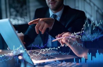 Two colleagues in formal wear working together to optimize trading strategy at corporate finance fund. Forex chart hologram over modern office background