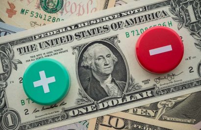 Plus and Minus symbol on US dollar banknotes background. The Federal Reserve ( FED ) to cut or raises interest rates concept. Global world economy crisis, U.S. vs China trade war or currency war.