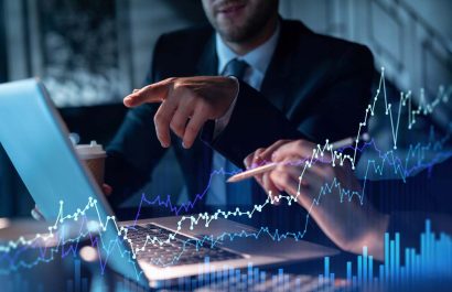 Two colleagues in formal wear working together to optimize trading strategy at corporate finance fund. Forex chart hologram over modern office background