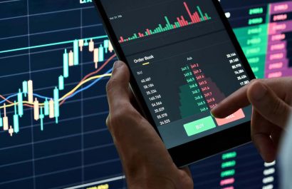 Crypto trader investor broker holding finger on buy or sell button executing financial stock trade market trading order thinking of cryptocurrency or shares assets investment risks and profit concept.