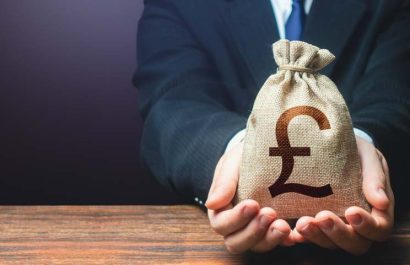 Businessman holds out british pound sterling money bag. Getting a grant. Mortgage, loan approval. Salary, benefits, profit. Attracting investments. Deposit savings. Banking and crediting. Easy Money.