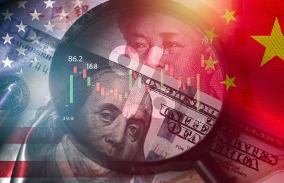 Magnifier glass focus on USD dollar and Yuan banknote with USA and China flag .It is symbol of economic tariffs trade war ,tax barrier and tech competition which it effect to global economy concept.