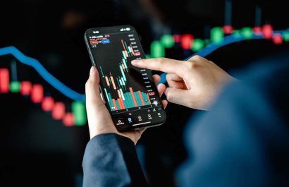 Investors analyze the data stock market index via smartphone screen to trade the stock chart for planning investments take profit, trade stock exchange market and cryptocurrency data, financial.