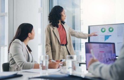 Data analysis, business meeting or woman with graph presentation in office for revenue, profit or sale statistics. Chart, analytics or accounting mentor brainstorming economy, inflation or solution
